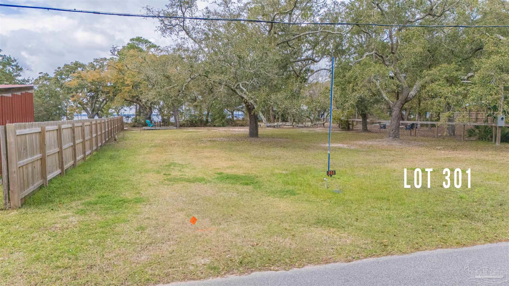 301 Katie Street Milton, FL 32583 - Photo 10 of 16 a view of a yard with wooden fence