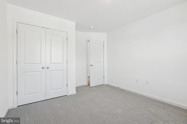 an empty room with closet area