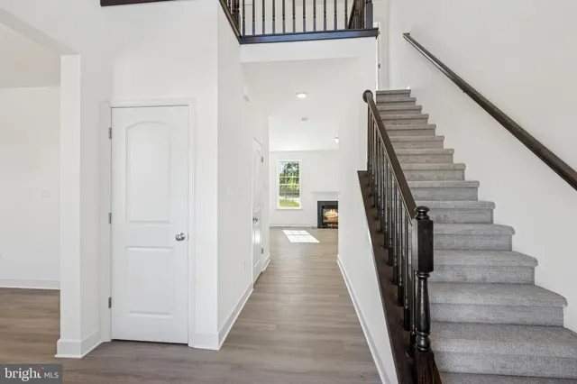 a view of a hallway with wooden floor and entryway
