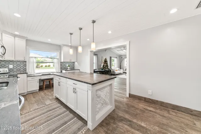 a kitchen with stainless steel appliances granite countertop a stove a microwave a sink a microwave and a refrigerator