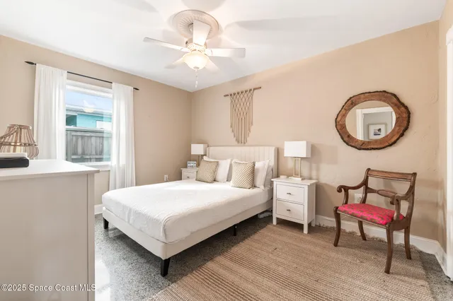 a bedroom with furniture and a large window