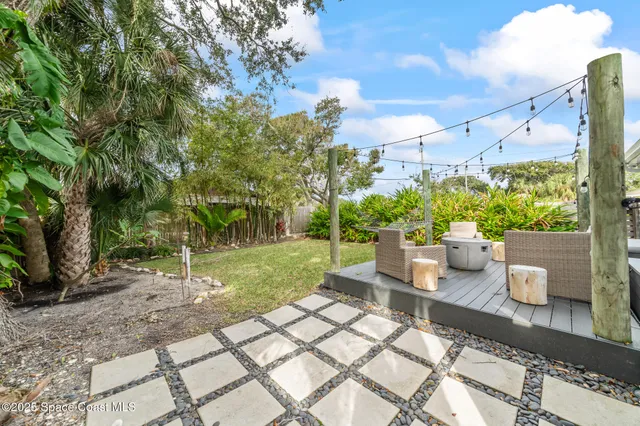 a view of a house with backyard and sitting area