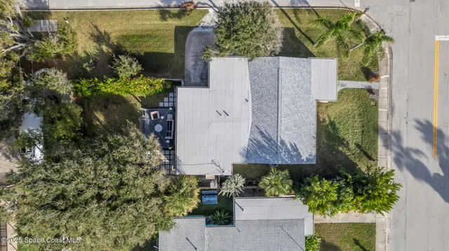 an aerial view of residential houses with outdoor space and street view