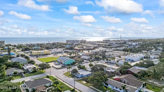 an aerial view of residential building and ocean