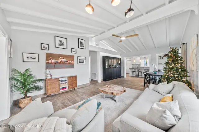 a kitchen with stainless steel appliances granite countertop a dining table chairs sink refrigerator and microwave