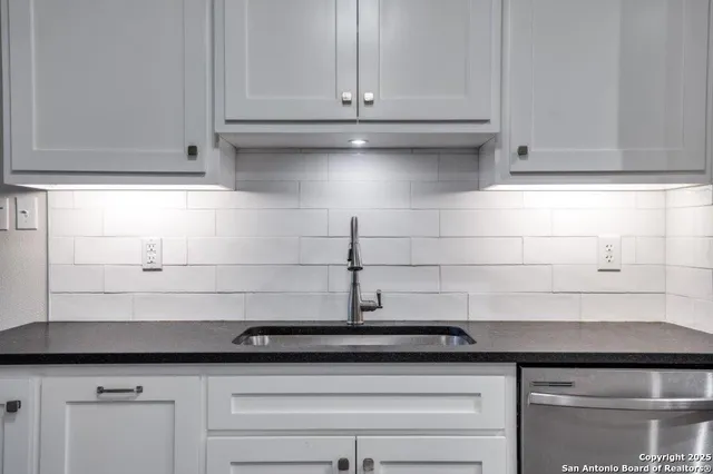a bathroom with a double vanity sink and a mirror