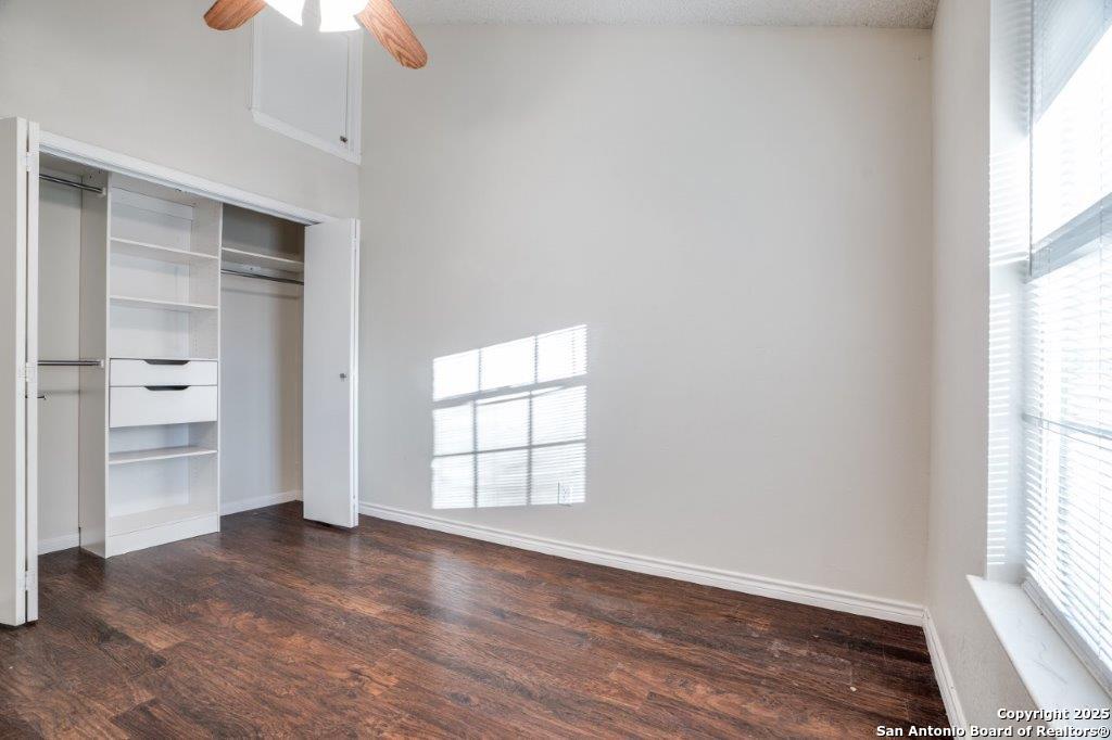 218 Ebner Street Boerne, TX 78006 - Photo 13 of 24 an empty room with wooden floor cabinet and windows