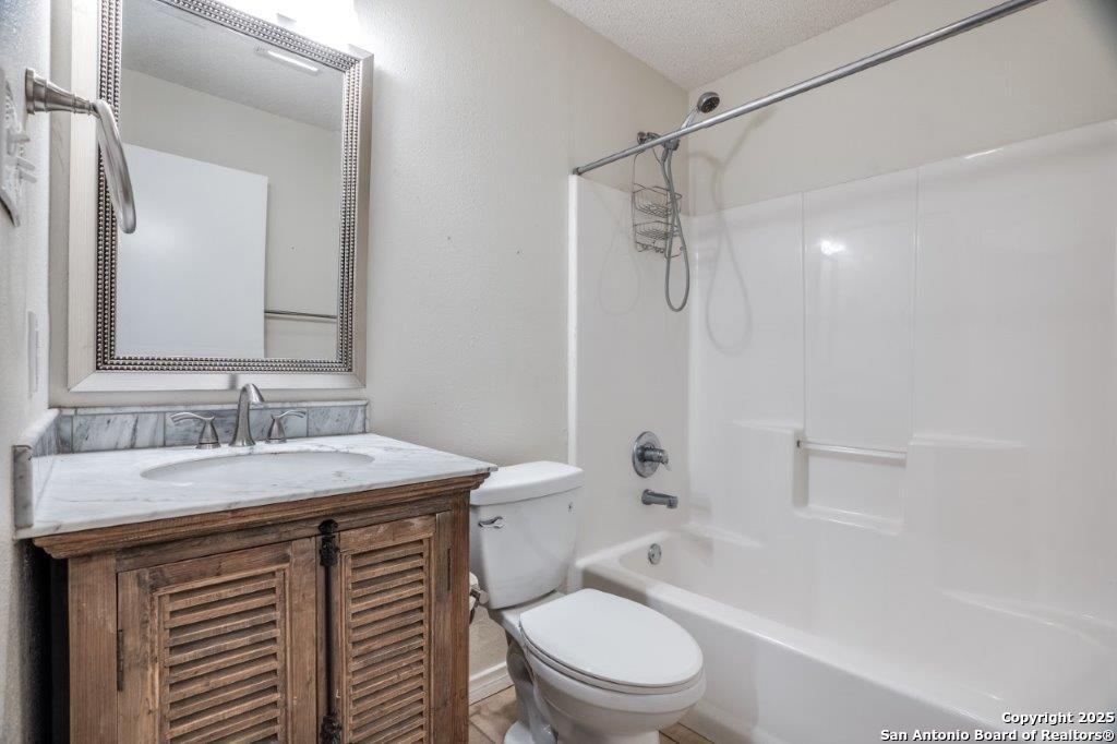 218 Ebner Street Boerne, TX 78006 - Photo 19 of 24 a bathroom with a sink a toilet and shower