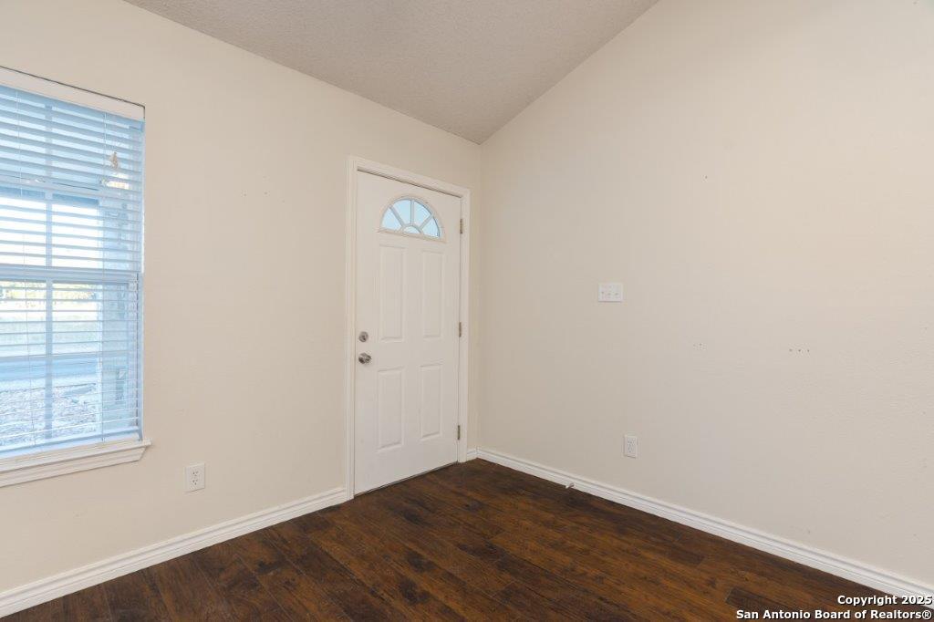 218 Ebner Street Boerne, TX 78006 - Photo 5 of 24 an empty room with wooden floor and windows