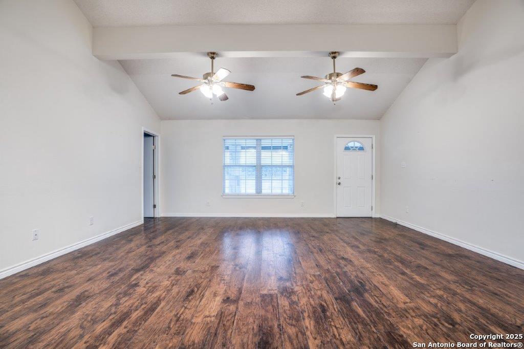 218 Ebner Street Boerne, TX 78006 - Photo 6 of 24 an empty room with wooden floor ceiling fan and window