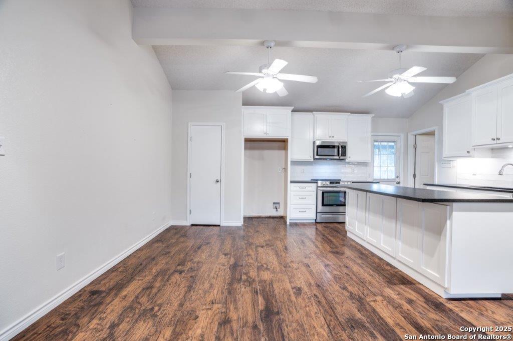 218 Ebner Street Boerne, TX 78006 - Photo 10 of 24 a kitchen with stainless steel appliances granite countertop a sink cabinets and wooden floor