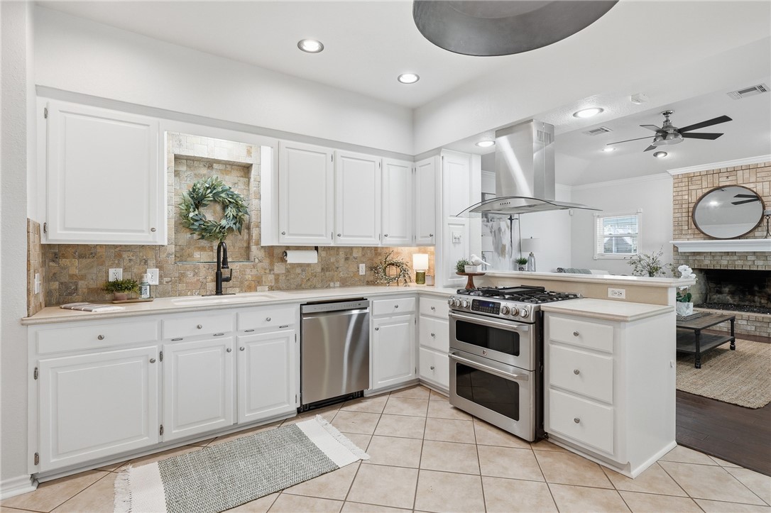616 Colonial Drive Portland, TX 78374 - Photo 11 of 35 a kitchen with a stove sink and cabinets