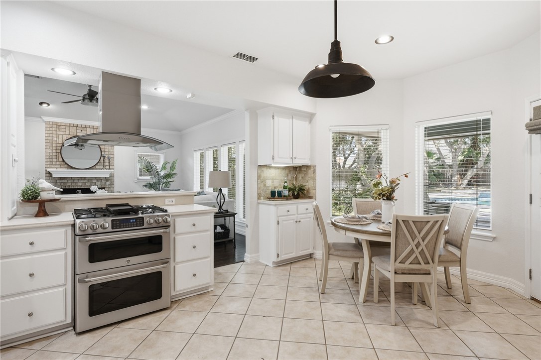 616 Colonial Drive Portland, TX 78374 - Photo 12 of 35 a kitchen with stainless steel appliances granite countertop a stove a sink and a refrigerator with wooden floor