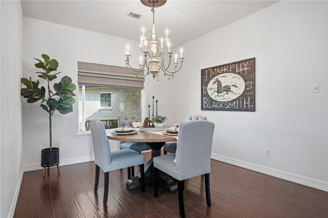 616 Colonial Drive Portland, TX 78374 - Photo 13 of 35 a view of a dining room with furniture a chandelier and wooden floor