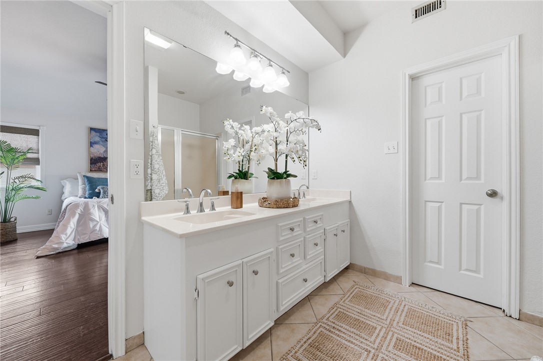 616 Colonial Drive Portland, TX 78374 - Photo 17 of 35 a en suite bathroom with double sink and a mirror