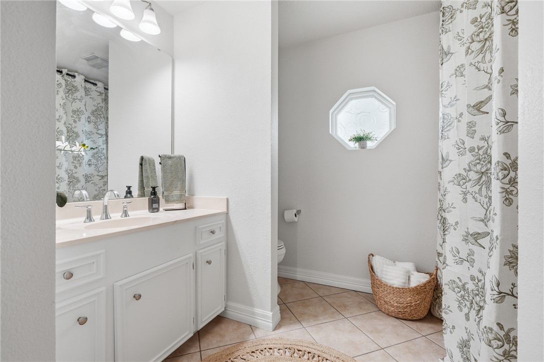 616 Colonial Drive Portland, TX 78374 - Photo 21 of 35 a bathroom with a sink mirror and toilet