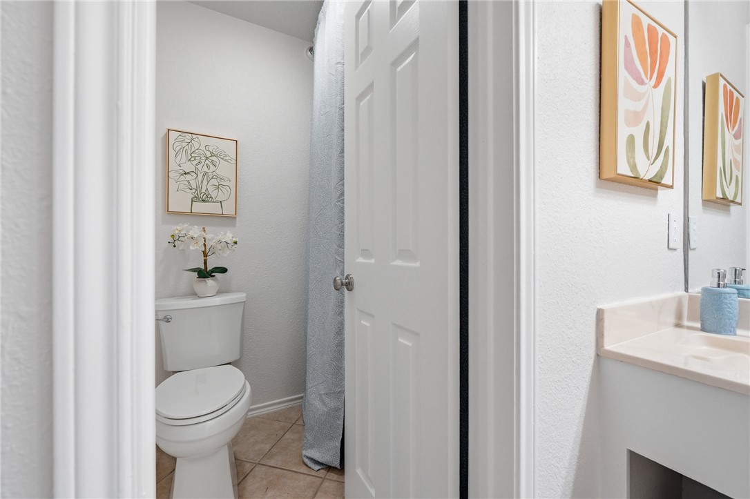 616 Colonial Drive Portland, TX 78374 - Photo 25 of 35 a bathroom with a toilet a sink and mirror