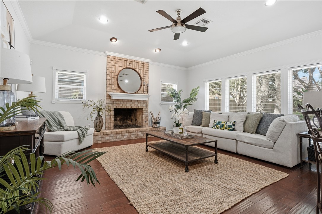 616 Colonial Drive Portland, TX 78374 - Photo 6 of 35 a living room with furniture a clock and a fireplace