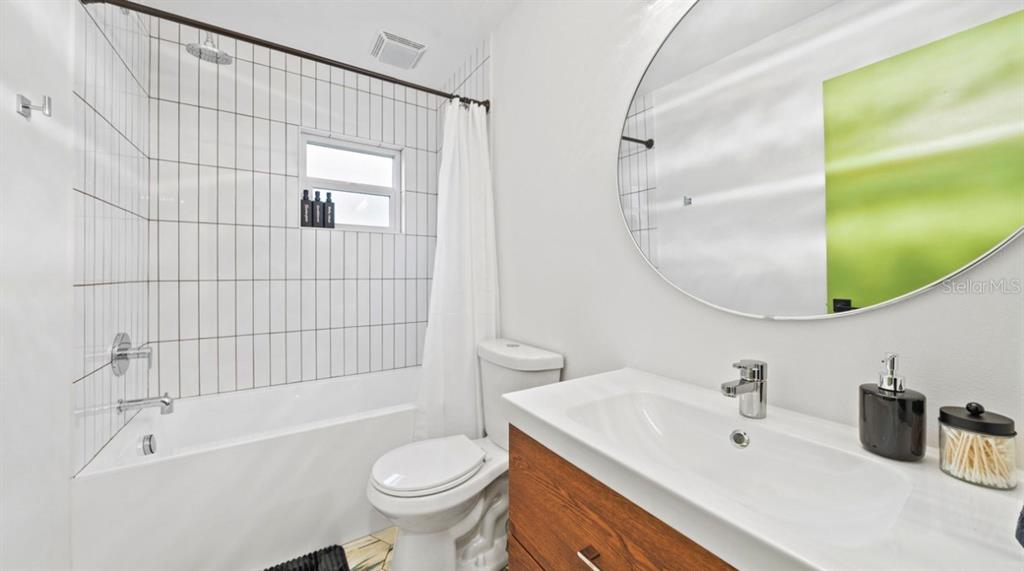 11123 117th Way Largo, FL 33778 - Photo 11 of 13 a bathroom with a sink a toilet and shower