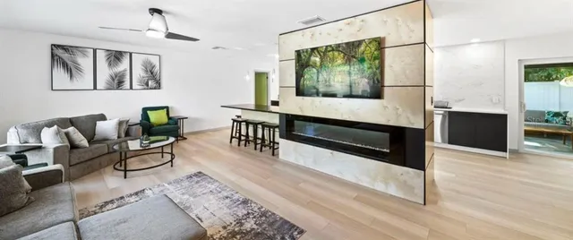 a living room with furniture and a wooden floor