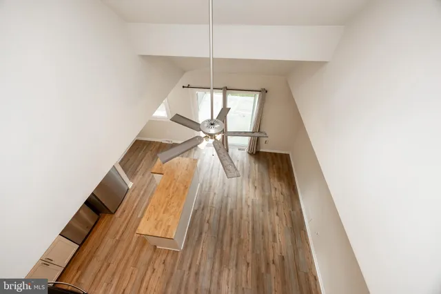a view of wooden floor a chandelier and entryway