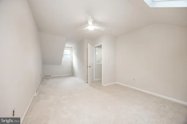 an empty room with a empty space and windows