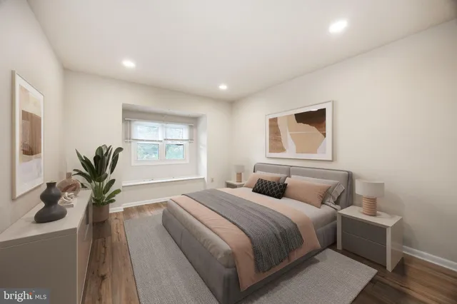 a bedroom with bed and a potted plant