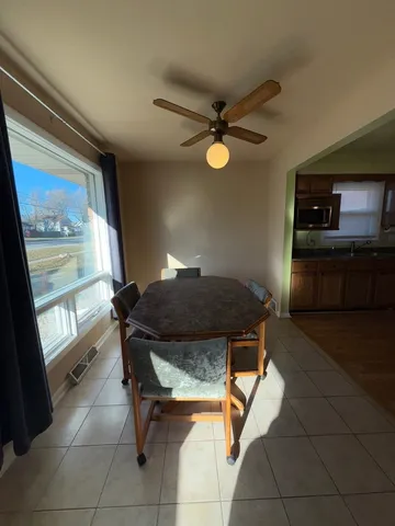 a living room with a table chairs and a window