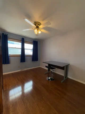 a room with wooden floor and pool table