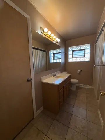 a bedroom with furniture and a lamp