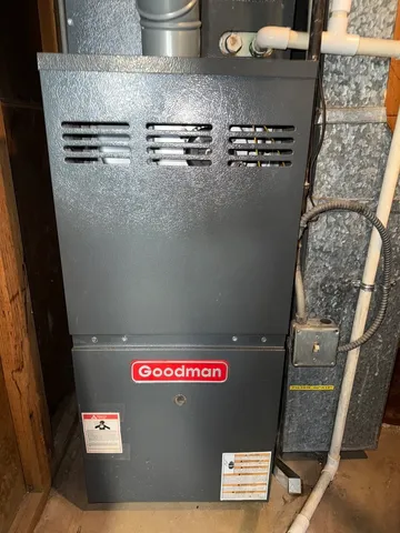 a view of a patio with lawn chairs under an umbrella