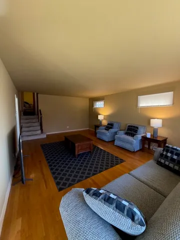a living room with furniture rug and lamp