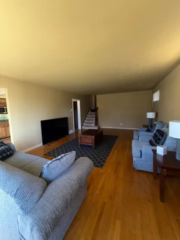 a bedroom with furniture and a wooden floor