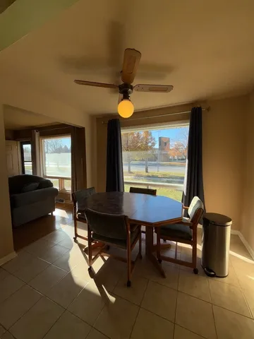 a living room with a table chairs and a chandelier