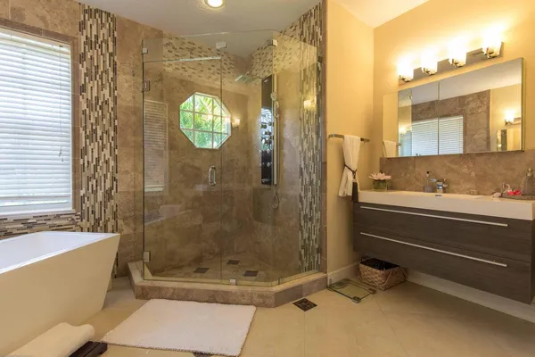 a bathroom with a tub and shower