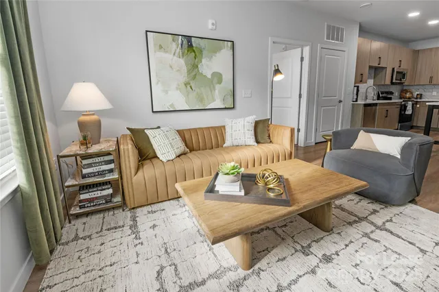 a living room with furniture a refrigerator and a table