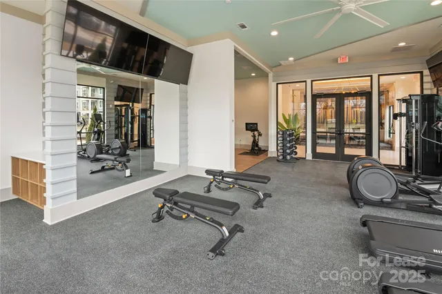 a room with gym equipment and a large window