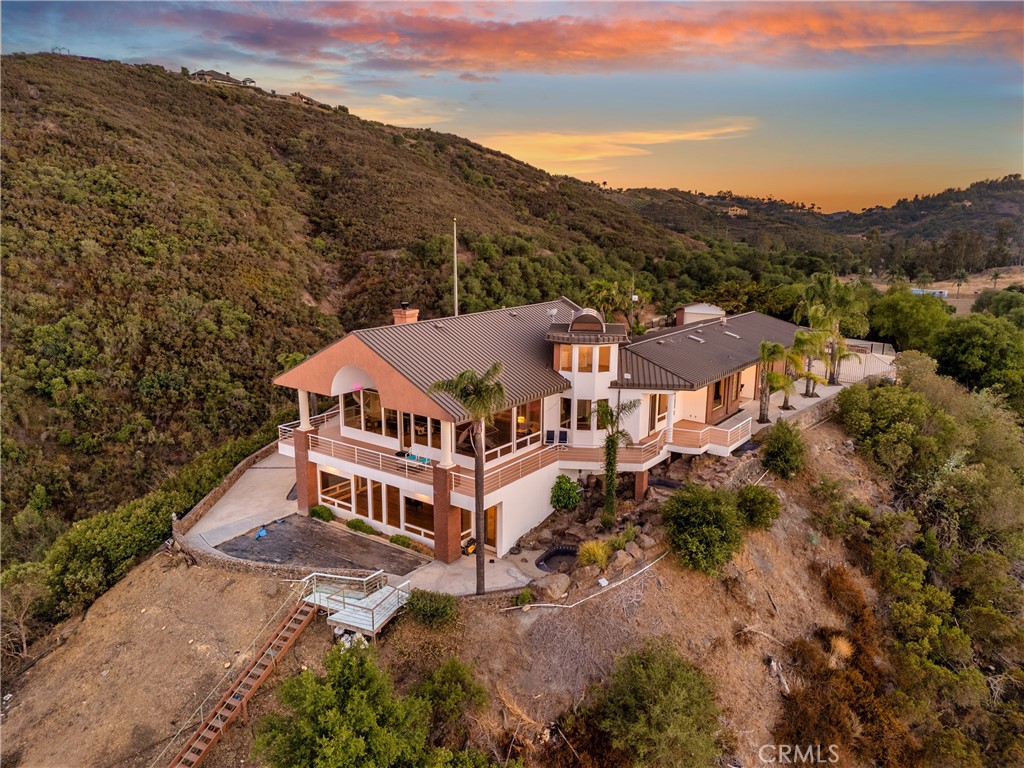 a view of a house with a mountain in the background
