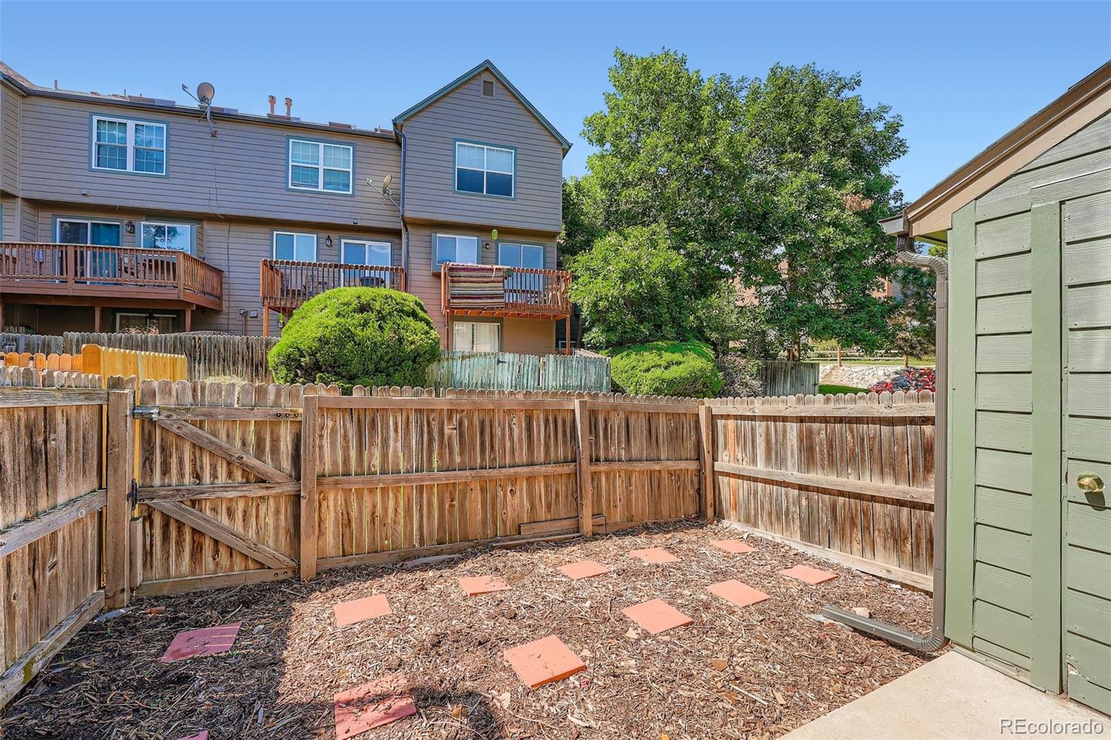 17315 East Rice Circle, Unit G Aurora, CO 80015 - Photo 17 of 31 a view of a brick house with wooden fence