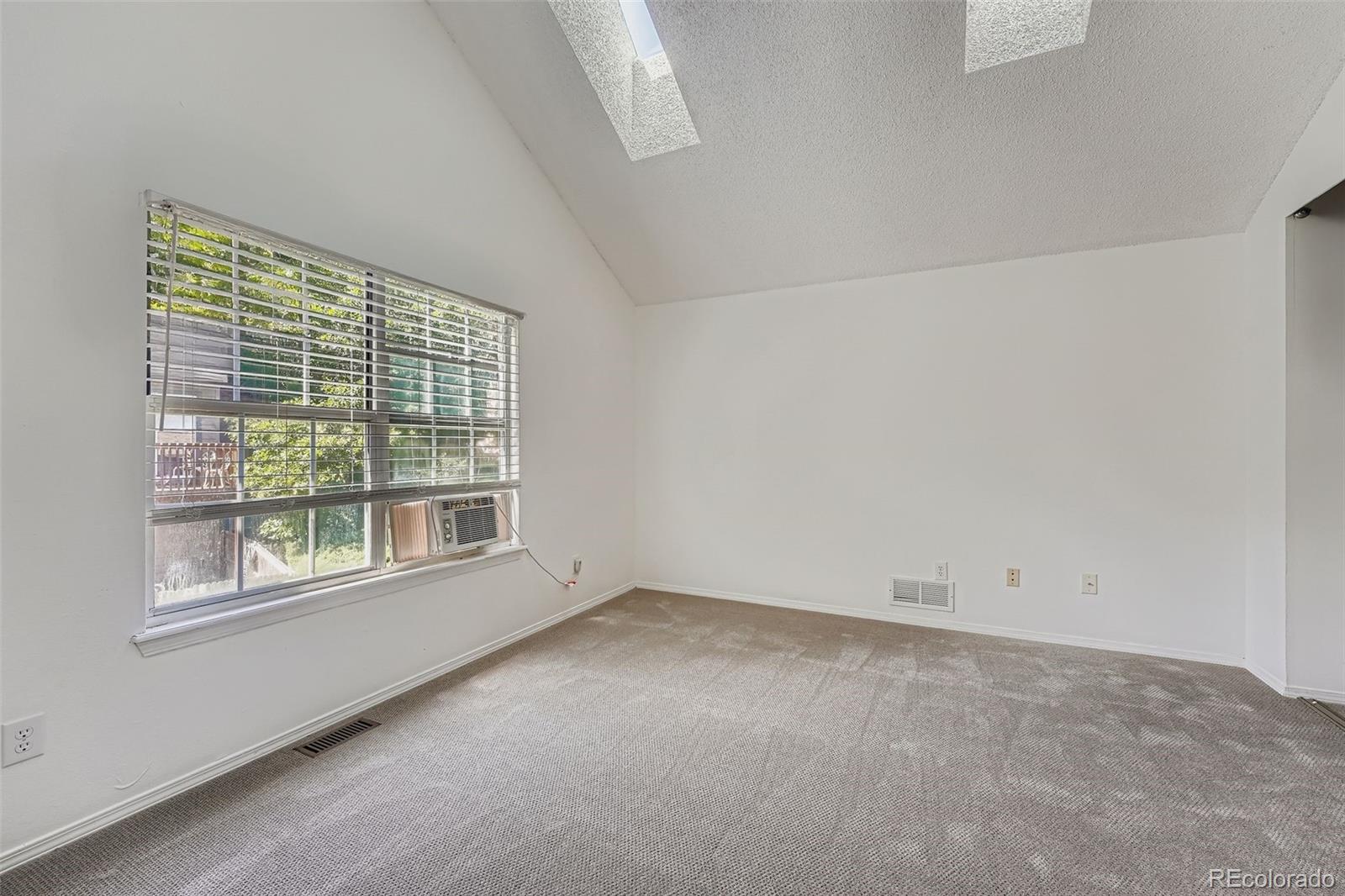 17315 East Rice Circle, Unit G Aurora, CO 80015 - Photo 19 of 31 an empty room with a window