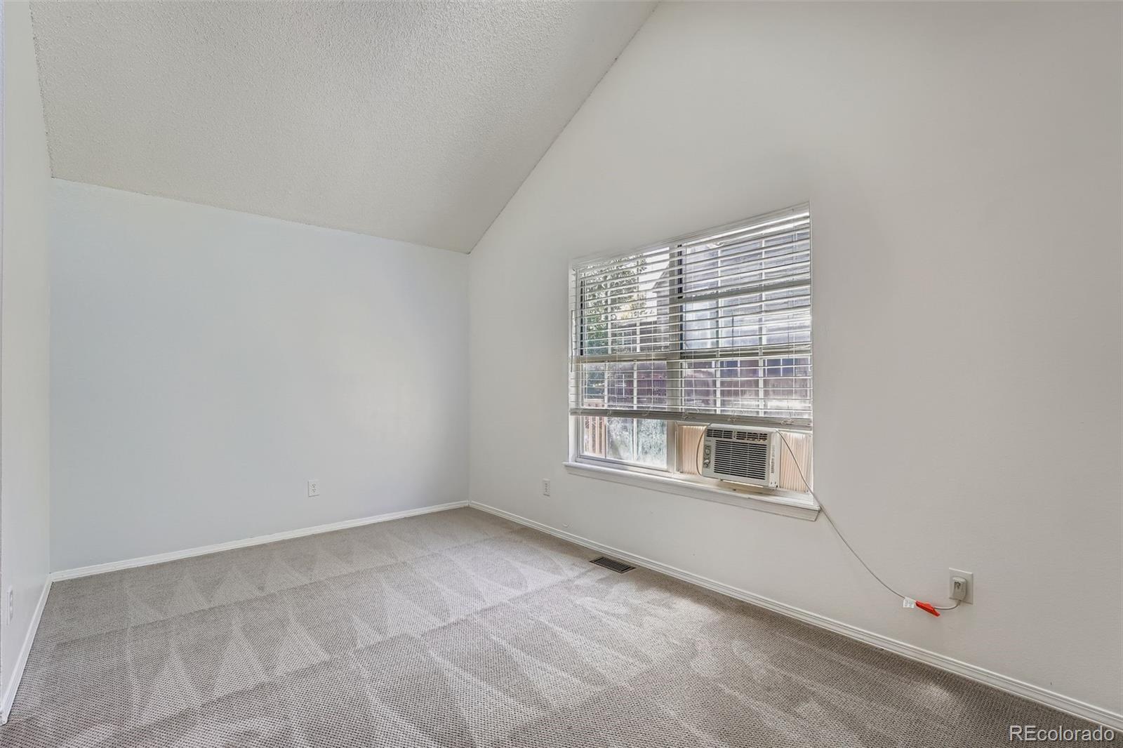 17315 East Rice Circle, Unit G Aurora, CO 80015 - Photo 23 of 31 a view of an empty room with a window