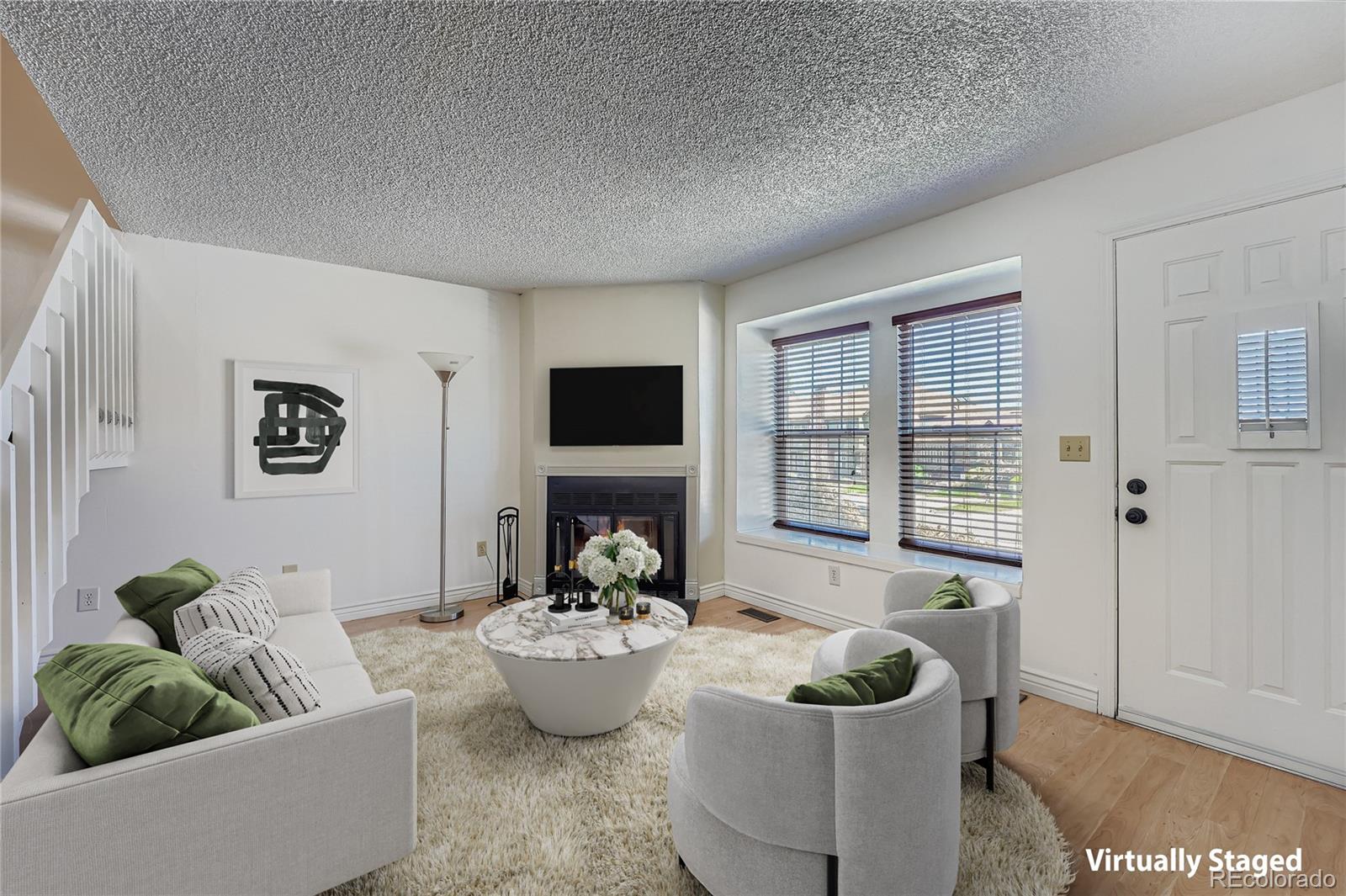 17315 East Rice Circle, Unit G Aurora, CO 80015 - Photo 3 of 31 a living room with furniture and a potted plant