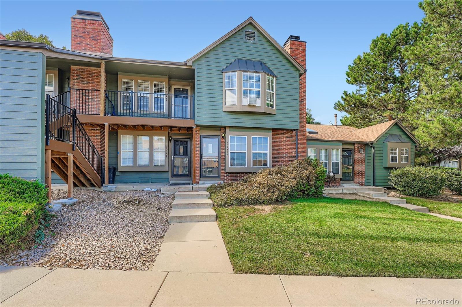 17315 East Rice Circle, Unit G Aurora, CO 80015 - Photo 31 of 31 a front view of a house with a yard