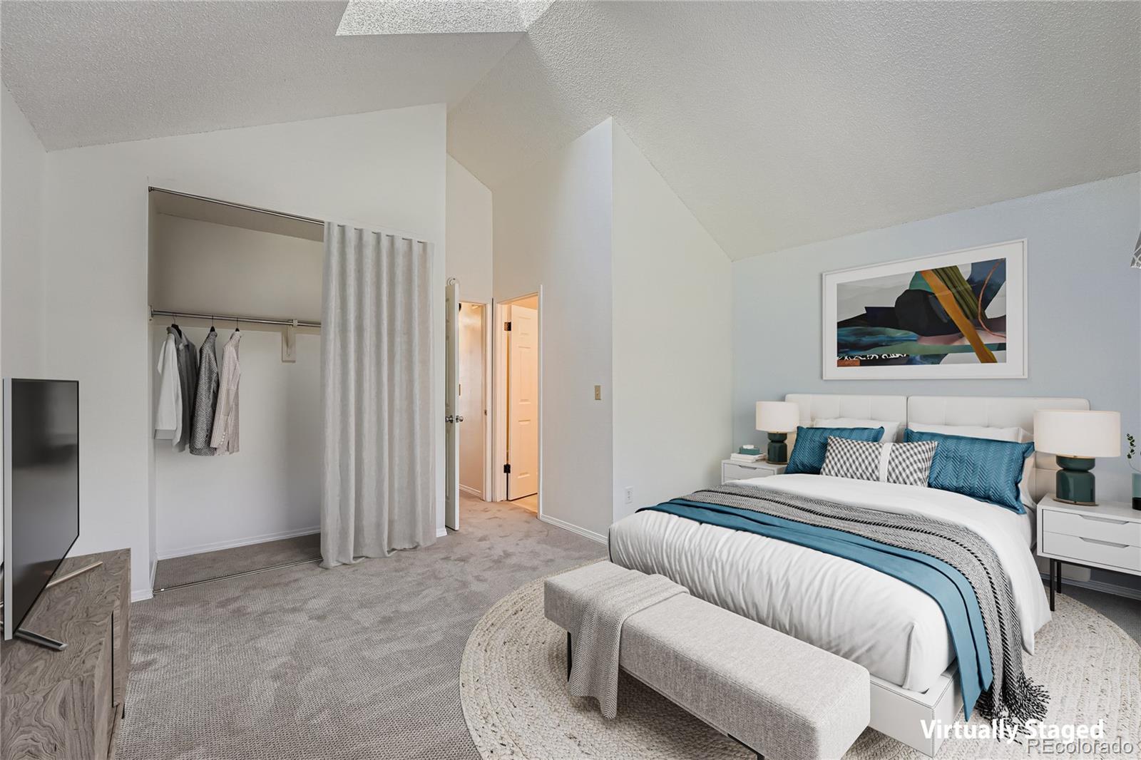 17315 East Rice Circle, Unit G Aurora, CO 80015 - Photo 4 of 31 a bedroom with a bed and a painting on the wall