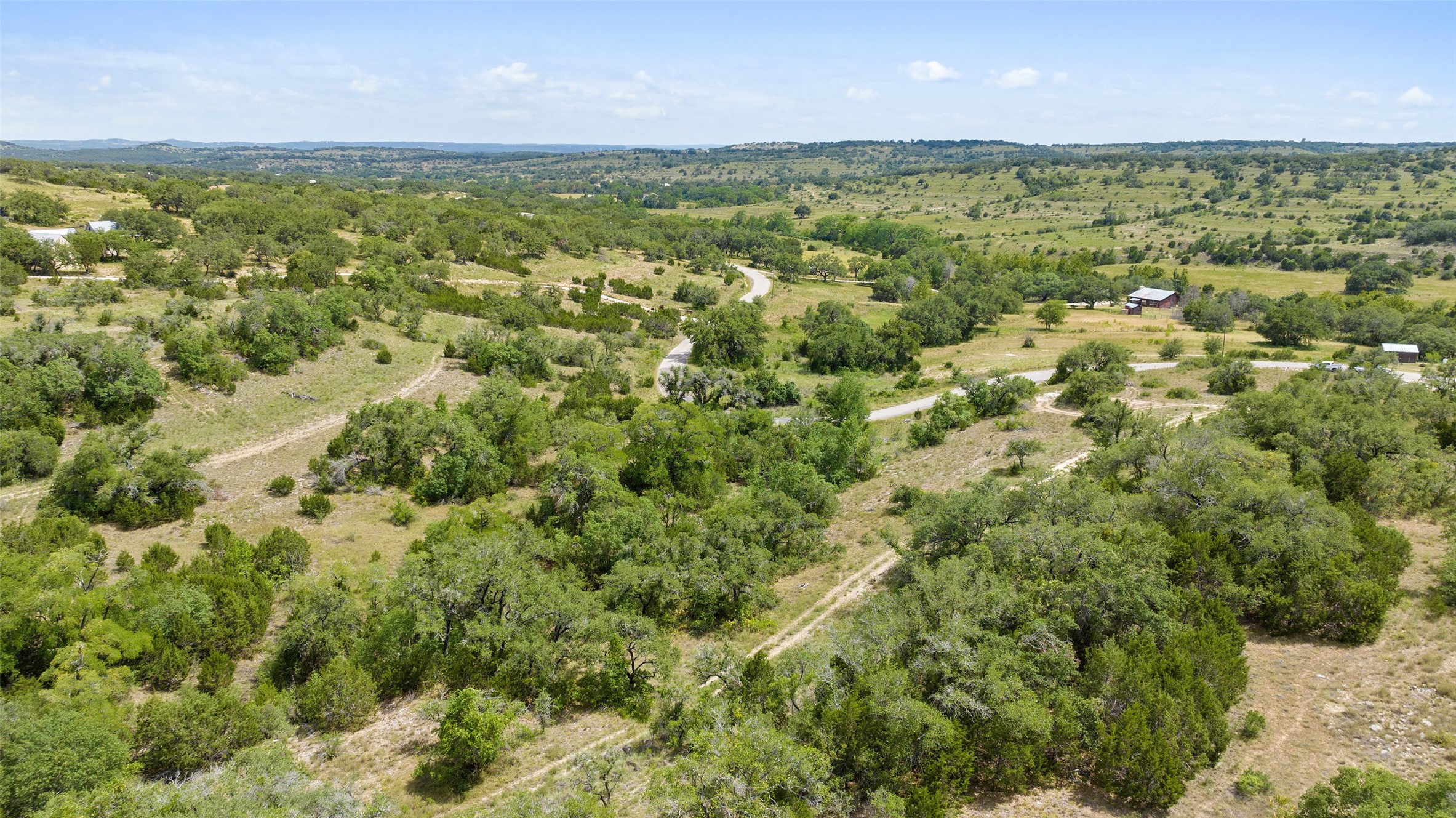 Tbd Fall Creek Road Spicewood, TX 78669 - Photo 2 of 13 a view of a green field with lots of trees in it