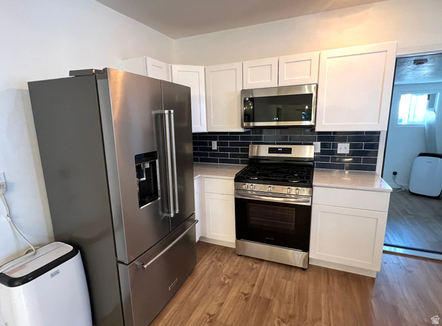 545 23rd Street Ogden, UT 84401 - Photo 5 of 28 Kitchen featuring wood-finish flooring, white shaker-style cabinetry, and light-toned countertops