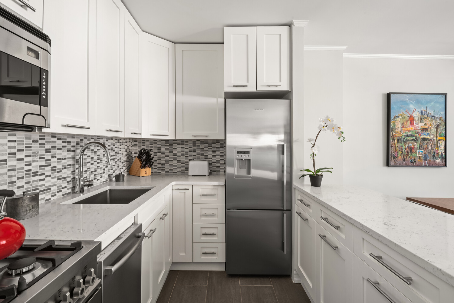 200 West 79th Street, Unit 12P Manhattan, NY 10024 - Photo 5 of 10 a kitchen with granite countertop a sink stove and cabinets