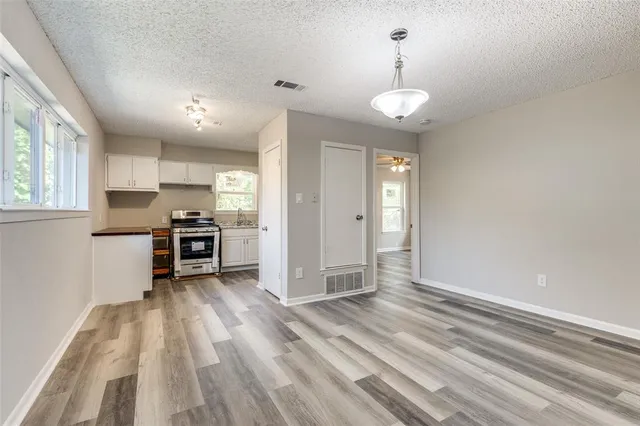 a view of kitchen with sink microwave and cabinets