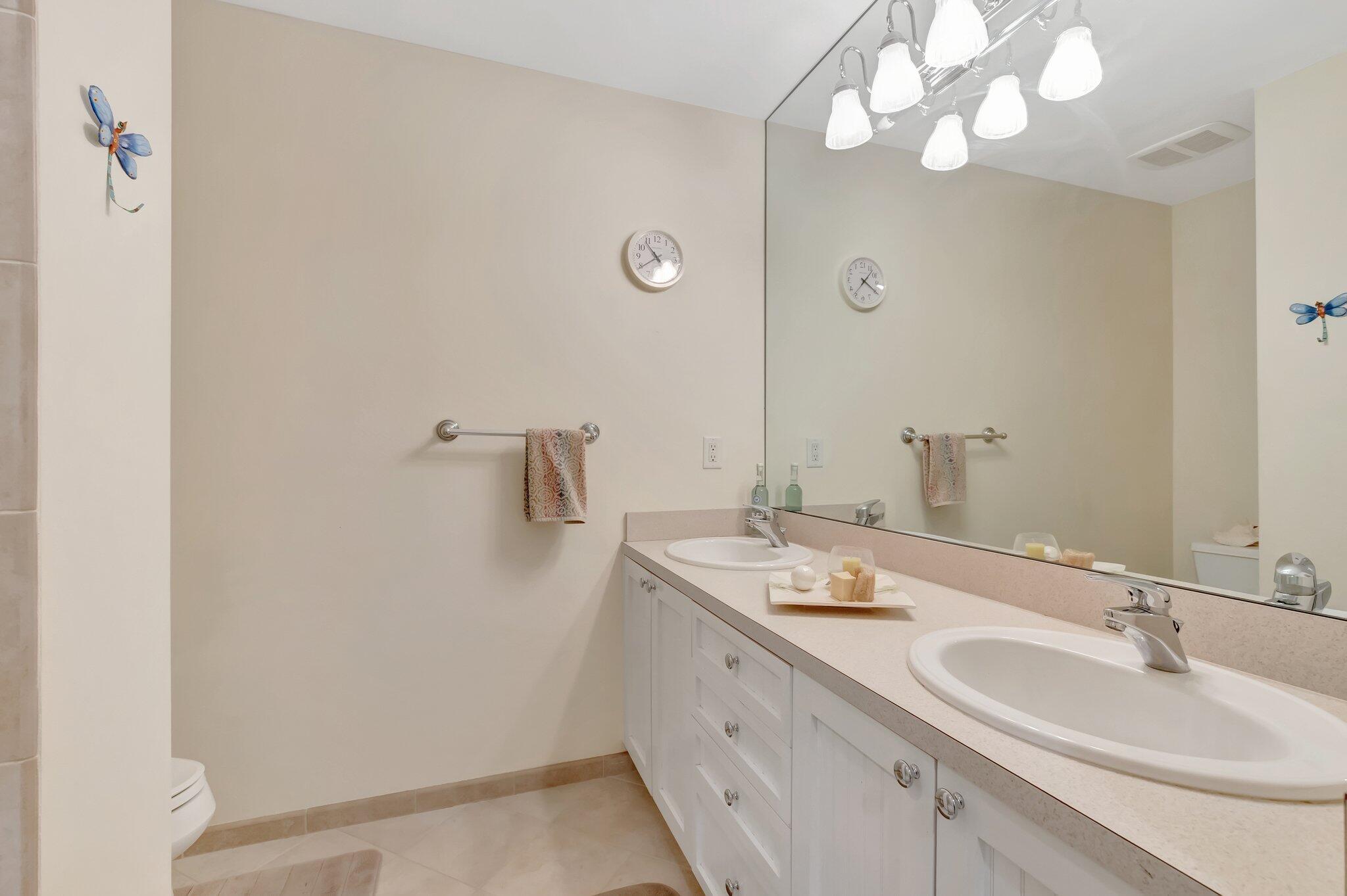 166 Southwest 8th Avenue Boca Raton, FL 33486 - Photo 13 of 25 a bathroom with a sink vanity and a mirror