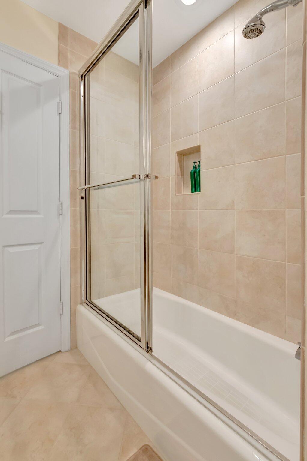 166 Southwest 8th Avenue Boca Raton, FL 33486 - Photo 14 of 25 a bathroom with a shower and a bath tub